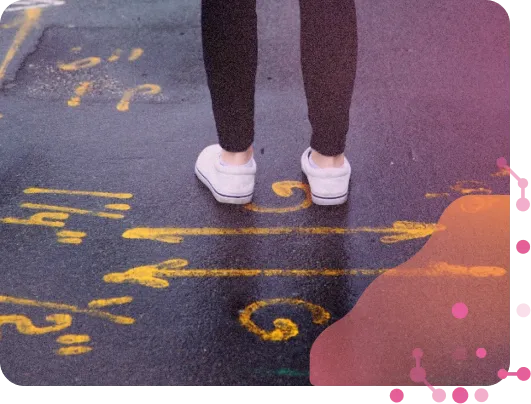 Arrows drawn on tarmac and a man standing next to them